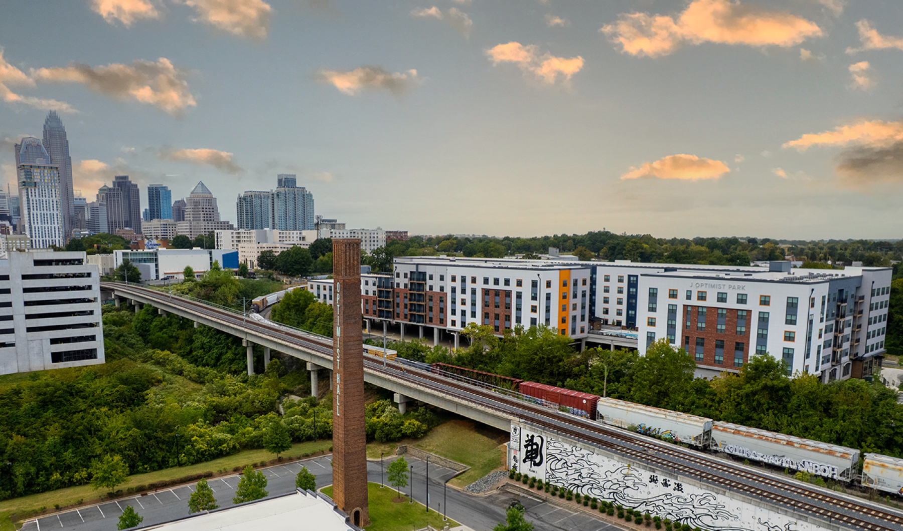 Optimist Hall  Apartments near Charlotte skyline and Optimist Hall in Forground